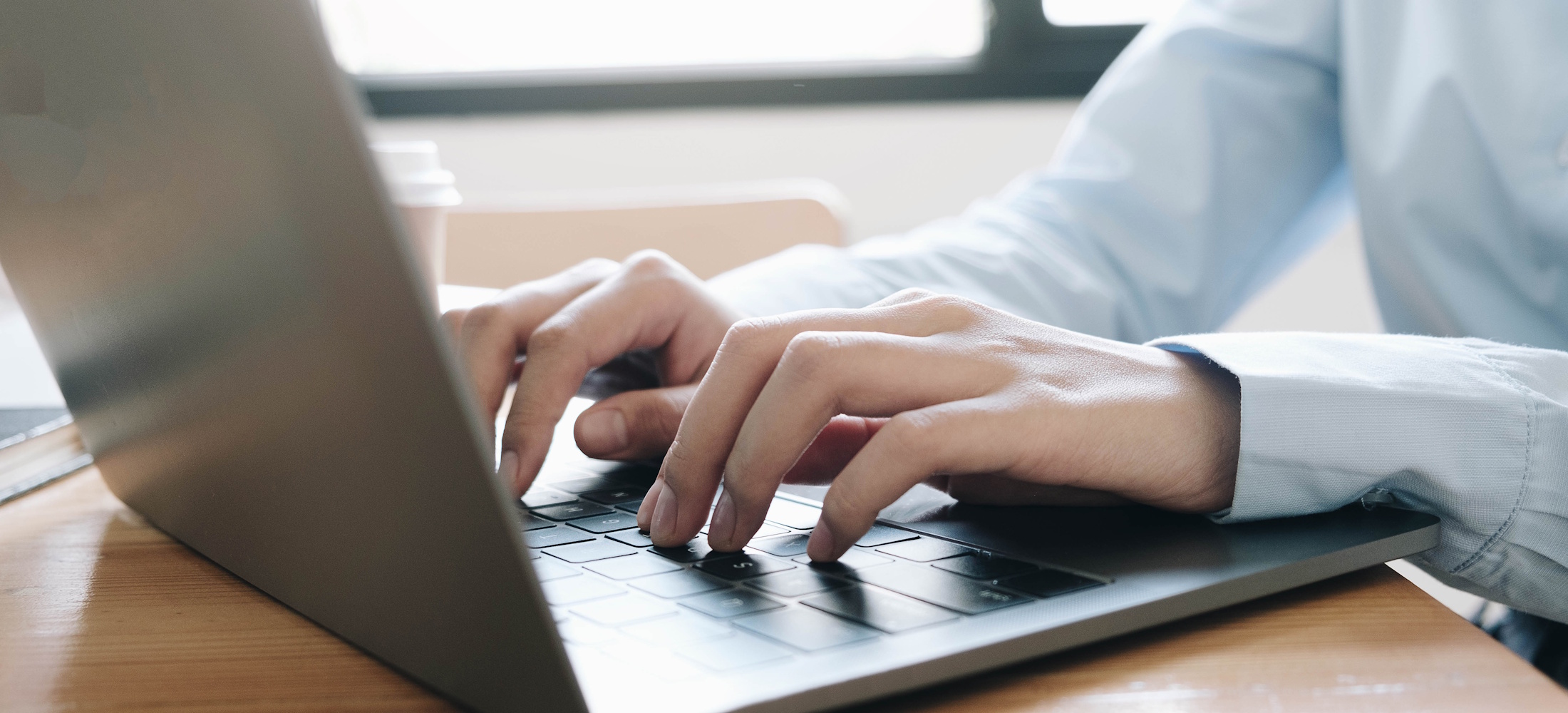 Person writing on laptop